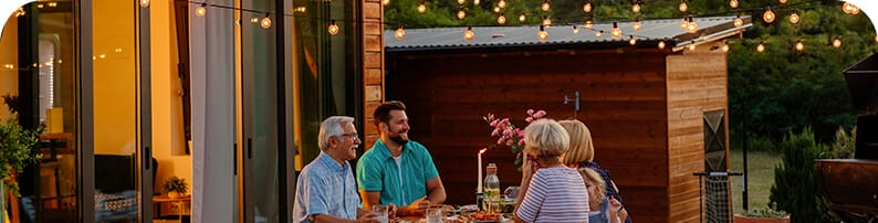 Happy family sitting outside at night