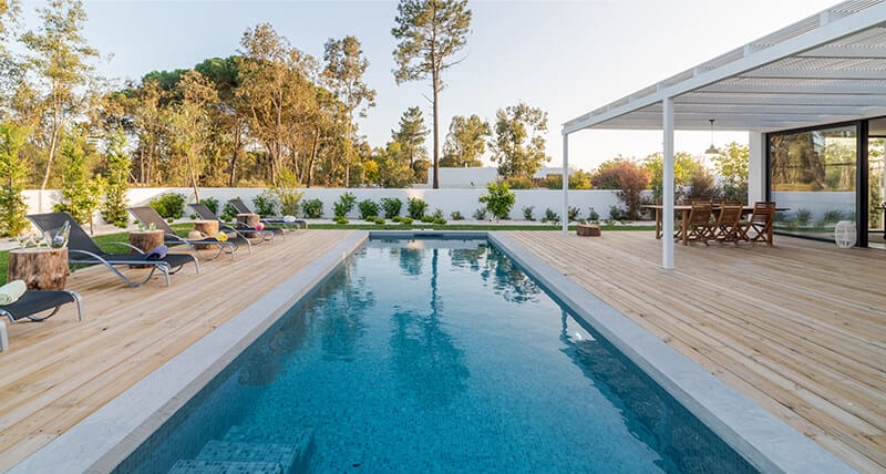 Harmonious shot of a rectangular pool, with wooden floor