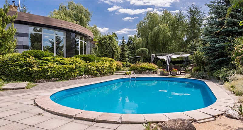 Rounded pool on a lush backyard